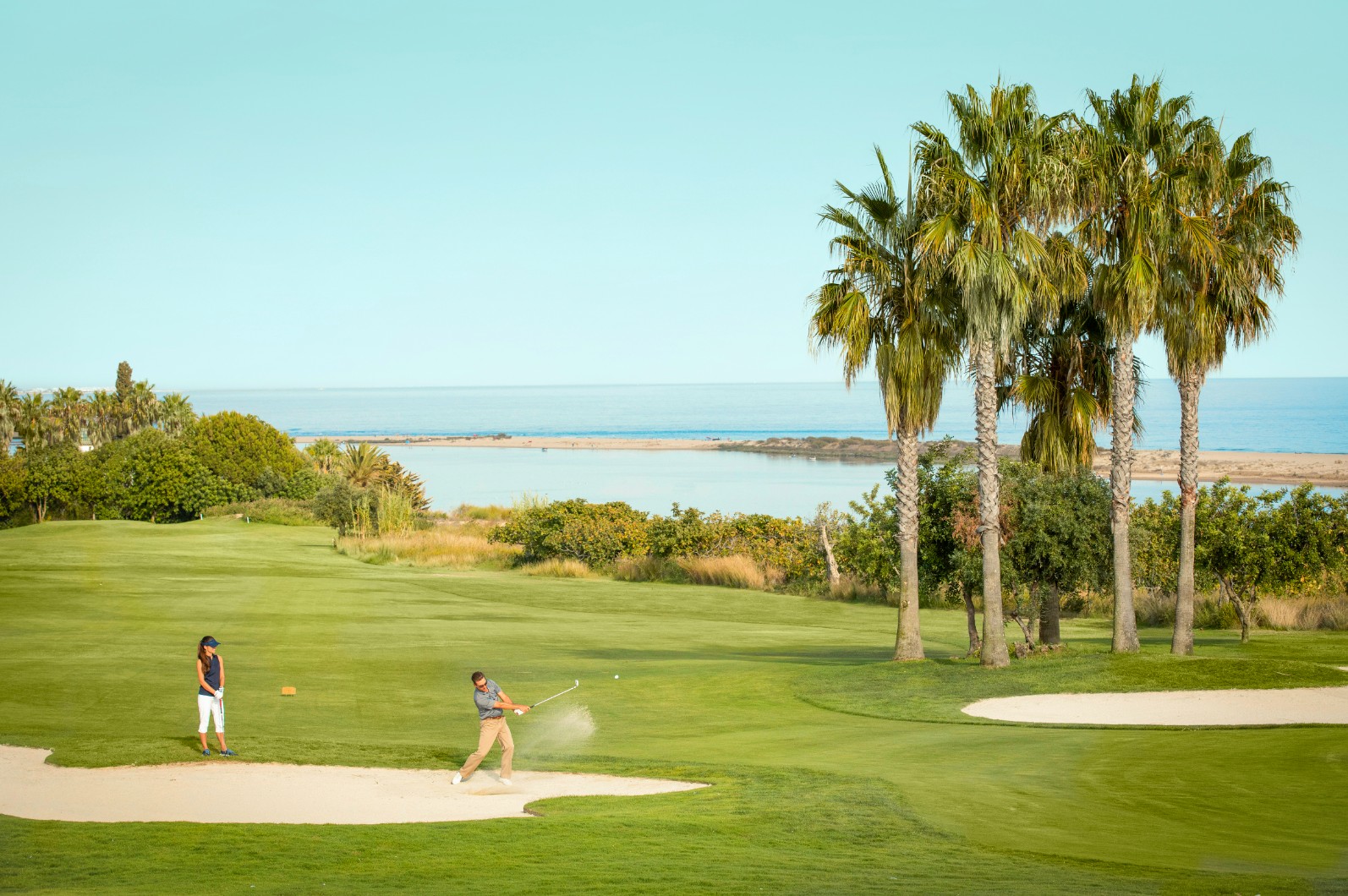 Golfers playing beside the sea at Quinta da Ria in the Eastern Algarve